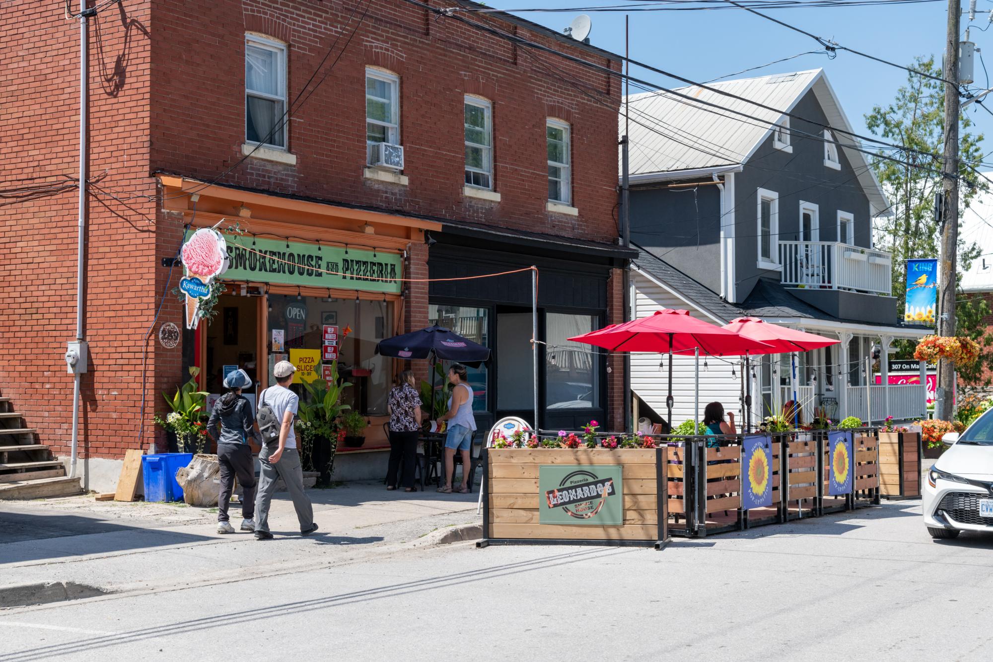 leonardo's pizzeria restaurant during summer with the street patio in front of the building