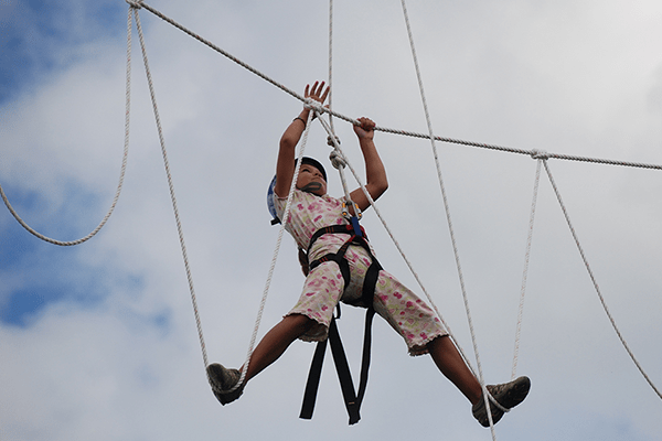 person climbing the high rope course at cold creek conservation area