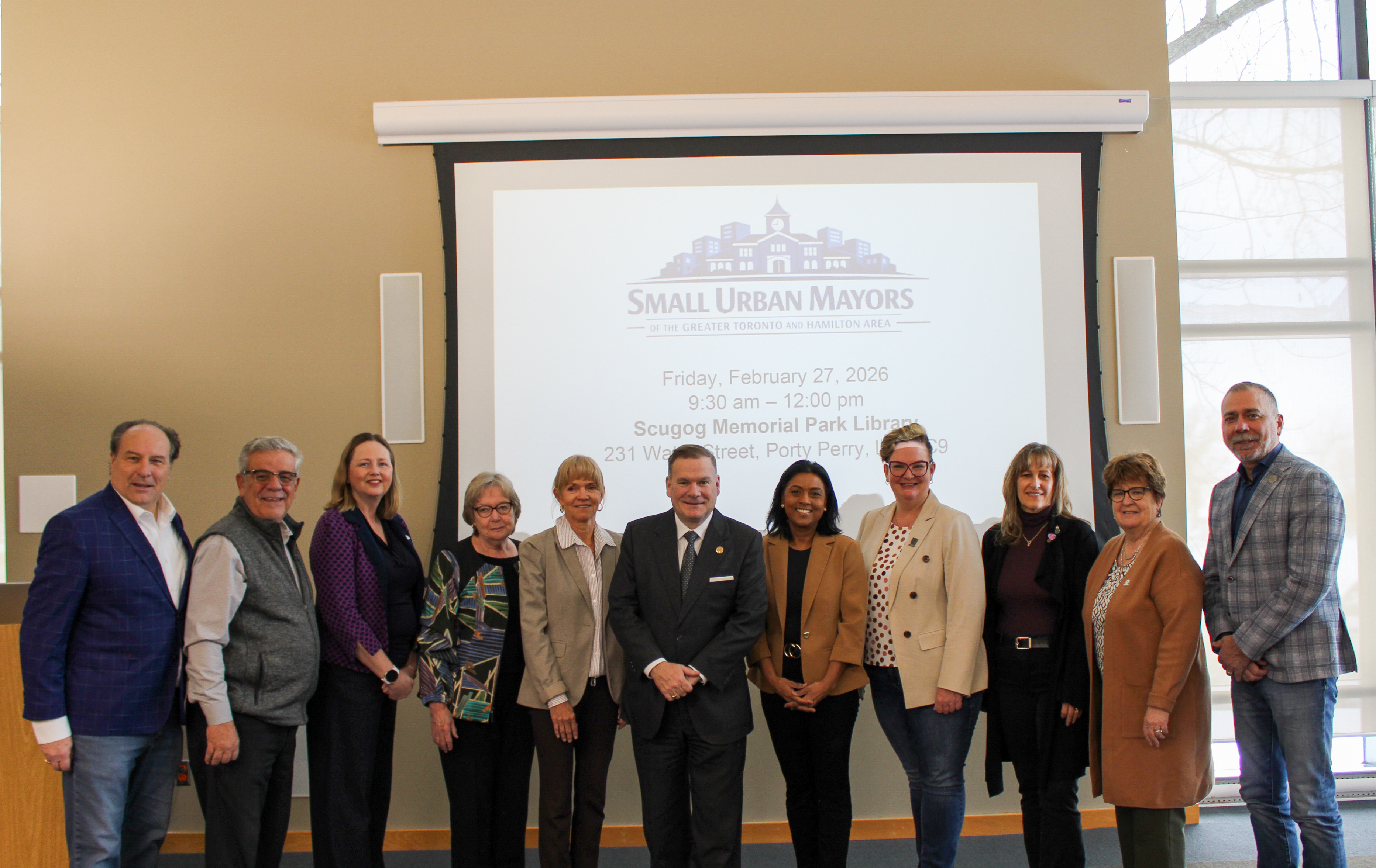 Small Urban Mayors of the Greater Toronto and Hamilton Area (GTHA) standing with Minister Todd McCarthy