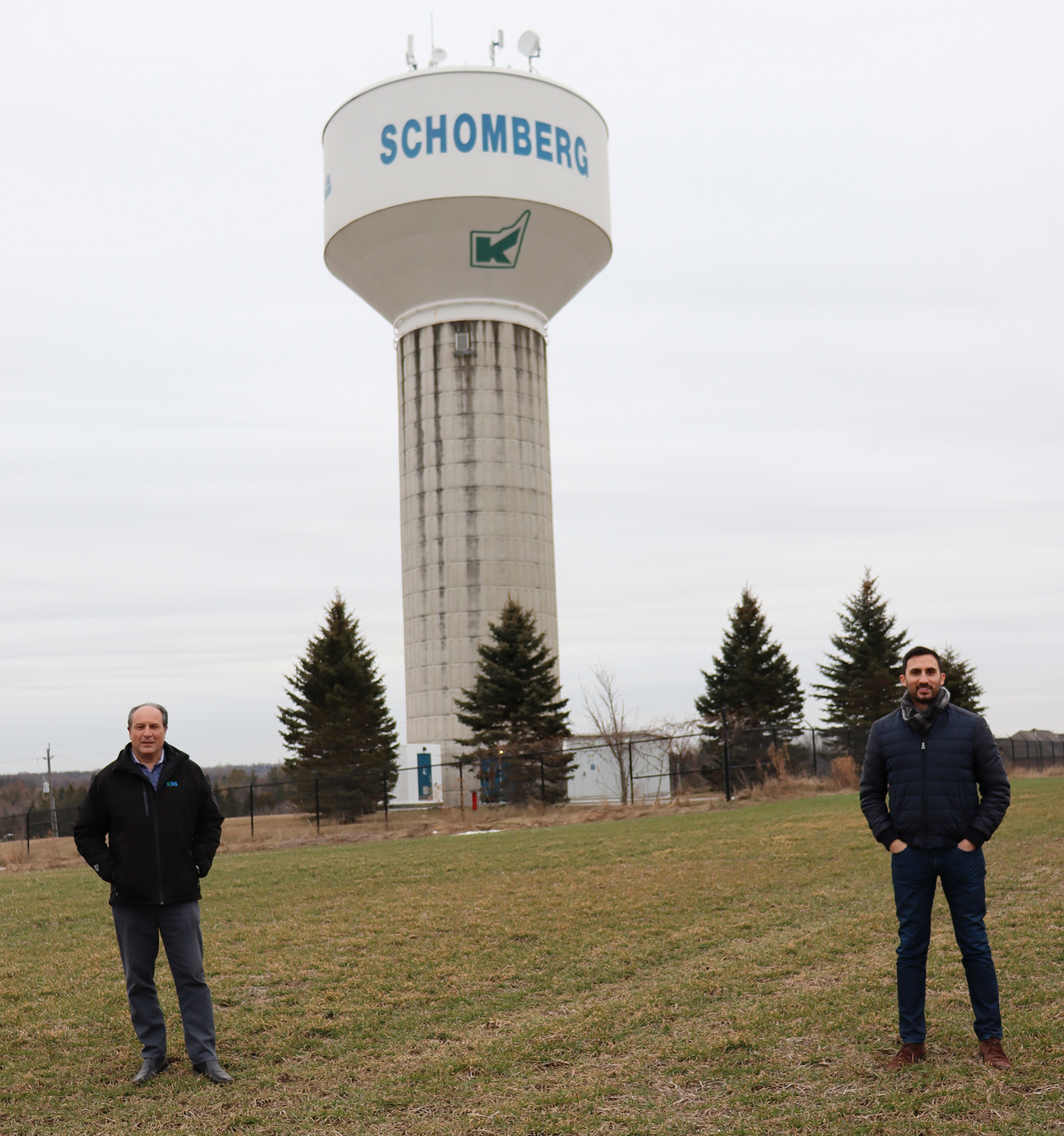 King Township Mayor Steve Pellegrini (left) and Stephen Lecce, MPP (King-Vaughan) and Minister of Education, stand in front of the Schomberg water tower. King recently received Ontario Community Infrastructure Funds to make repairs and upgrades to the municipal water system in Schomberg. 