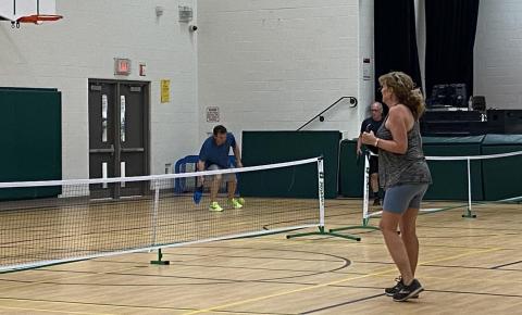 Adults playing pickleball