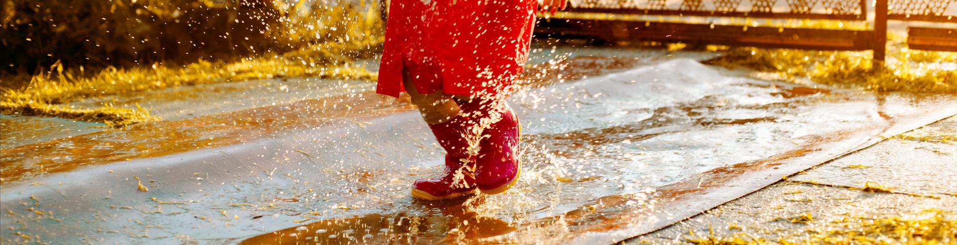 girl jumping in puddles 