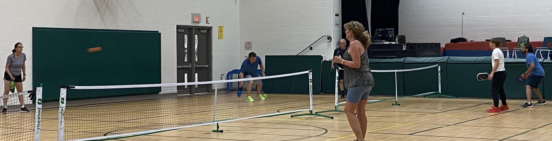 Adults playing pickleball