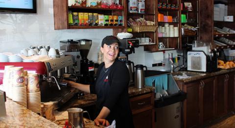 Person attending to coffee machine