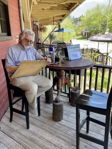 image of caricature artist working on a drawing