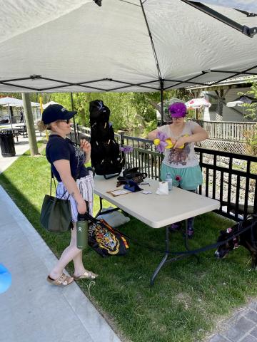 Image of balloon twister making a character for event attendee