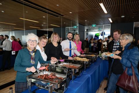 Council members serving breakfast food