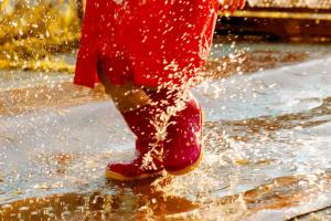 girl jumping in puddles 