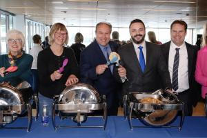 Mayor and Council serving breakfast food